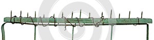 Old aged weathered green painted metallic vintage fence gate, large detailed upward driven nails closeup panorama, isolated