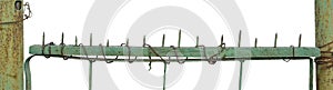 Old aged weathered green painted metallic vintage fence gate large detailed upward driven security nails closeup panorama isolated