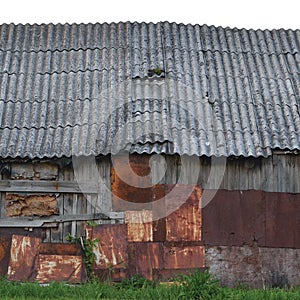 Old aged weathered wooden shack, grey plated wood boarding hut wall, patched planks, rusted metal plates, rusty paint texture