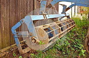 Old agricultural machine with rust and dirt on it, rustic farm e