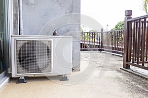 Old air conditioner compressor on balcony