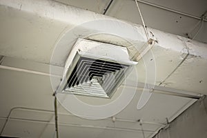 Old air conditioner hole pipe vent with grill air flow distributor in office need to clean