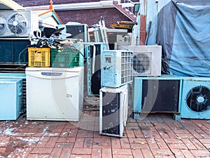 Old air conditioners and refrigerators on street