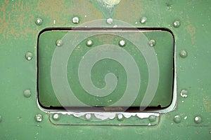 Old aircraft green hatch with rivets