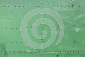 Old aircraft green painted aluminum texture with rivets