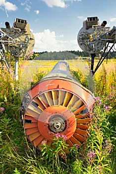 Old airplane fuselage on green grass