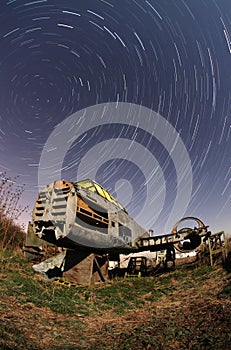Old airplane at night with star trails
