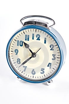 Old alarm clock on white background.