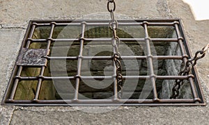 old aljibe security grille bars with chains a little rusty photo