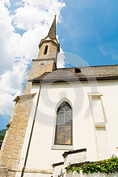 Old alpine church in picturesque mountain town.