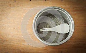 Old aluminium pot on a wooden background