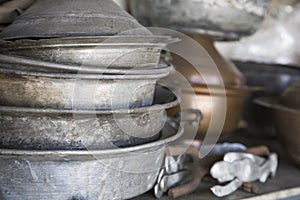 Old aluminium saucepans on a shelf