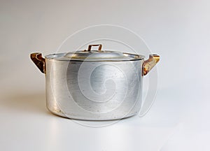 An old aluminum pan made in circa 1960 against a white background