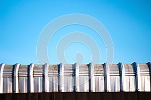 Old aluminum roof and bright blue sky background with vast space