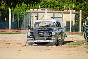 Old american car on beach in Trinidad Cuba