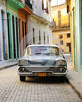 Old american car parked in Havana street