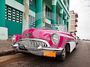 Old American retro car (50th years of the last century), an iconic sight in the city, on the Malecon street January 27, 2013 in O