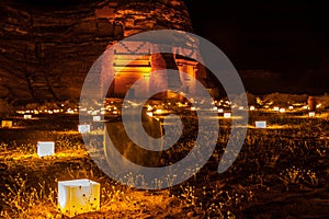 Old Amphora in front of ancient tombs of Hegra city illuminated during the night, Al Ula, Saudi Arabia