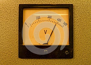 Old analog volt meter. Old measuring instrument with arrow and white scale