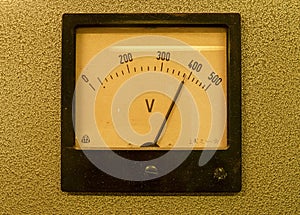 Old analog volt meter. Old measuring instrument with arrow and white scale