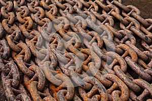 Old anchor chains, heavy, powerful, rusty, steel, lying in rows