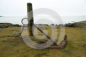 An old anchor by the coast at Valberg, Sweden.