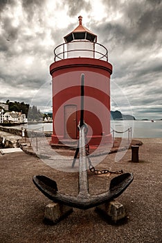 Old anchor and lighthouse in Alesund