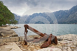 Old anchor on the seacoast on cloudy day. Montenegro, Bay of Kotor