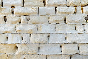 Old ancient brick wall affected by corrosion