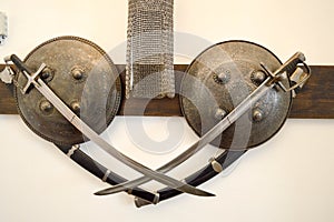 Old ancient medieval sharp dangerous combat captured swords, sabers, edged weapons and armor, shields