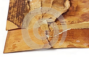 old ancient paper torn in pieces brought back together again, symbolic concept