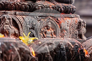 Old ancient stone structures with intricate details of statue of Hindu Gods and Goddesses carved at Swayambhunath Stupa in