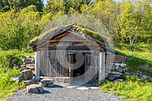 Old and ancient viking forge with traditional wooden build, decorated with viking runes and ornament.