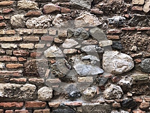 Old ancient wall with different stones as abstract background