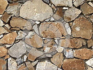 Old ancient wall with different stones as abstract background