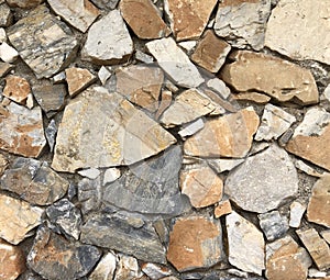 Old ancient wall with different stones as abstract background