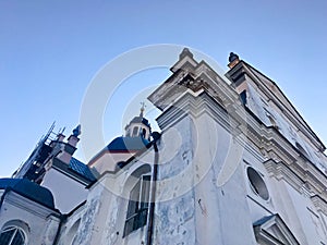 Old ancient white poor stone shabby Christian Orthodox church with crosses