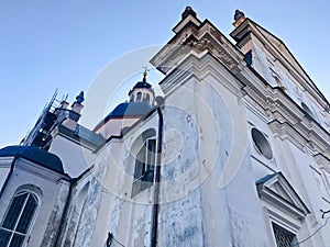 Old ancient white poor stone shabby Christian Orthodox church with crosses