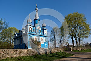 Old ancient wooden church of the Holy Life Giving Trinity in spring, Telyadovichi, Minsk region, Belarus photo