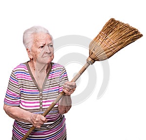 Old angry woman threatening with a broom