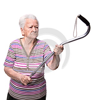 Old angry woman threatening with a cane photo