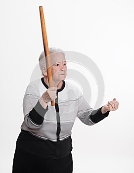 Old angry woman threatening with a rolling pin