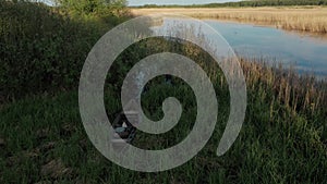 Old antic vintage wooden boat abandoned among tall reed grass outside Ukraine 4k aerial top view