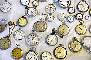 Old and antique clocks on white tablecloth in a stand of the Encantes Nuevas or Fira de Bellcaire, Barcelona photo