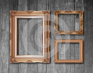 Old antique gold frame on wood texture background