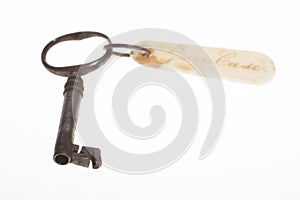 old antique key with badge on white