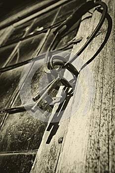 Old antique keys and ring against leaded window