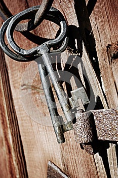 Old antique keys and ring against wood