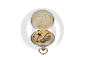 Old antique mechanical golden steel pocket watch with open lid isolated on white background.