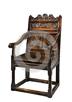 Old antique oak wainscot chair with carving isolated on white